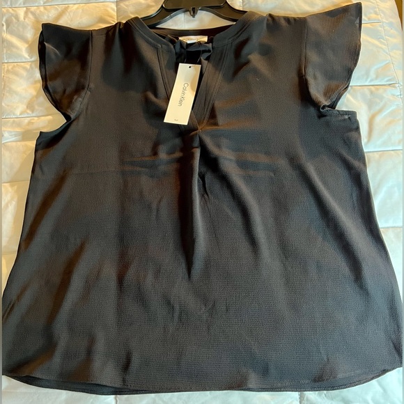 Calvin Klein Tops - NWT black Calvin Klein blouse. Women’s medium. Short sleeve 4BizandPleasure!